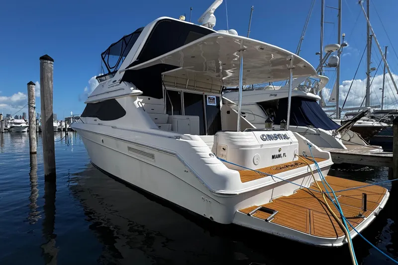 The Image of 1999 Sea Ray 440 Express Bridge yacht docked in marina, Miami, Florida. - 0