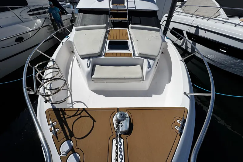 Slide: The Image of 1999 Sea Ray 440 Express Bridge yacht with spacious deck and seating area. - 15