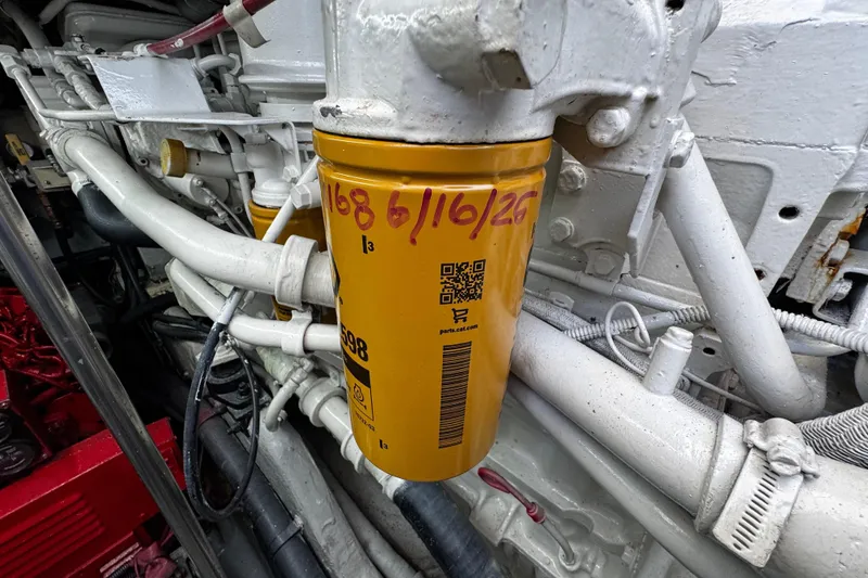Slide: The Image of Engine compartment of 1999 Sea Ray 440 Express Bridge with visible oil filter. - 45
