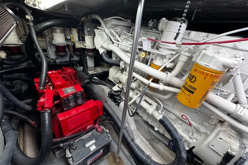 Slide: The Image of Engine room of a 1999 Sea Ray 440 Express Bridge, featuring red and white components. - 46