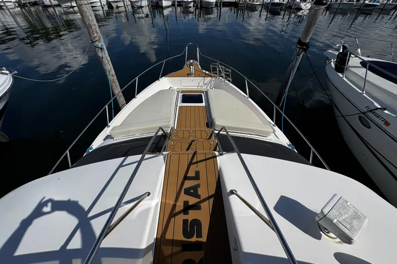 Slide: The Image of 1999 Sea Ray 440 Express Bridge yacht docked at marina, top deck view. - 8