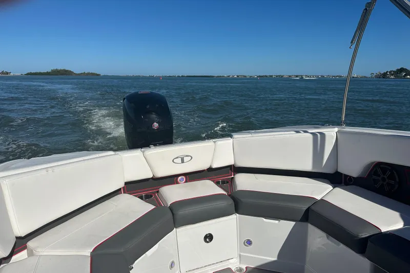 Slide: The Image of 2021 Tahoe 210 S boat interior with seating, cruising on open water. - 7