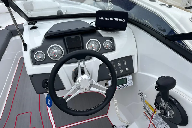 Slide: The Image of 2021 Tahoe 210 S boat dashboard with steering wheel and control panel. - 9