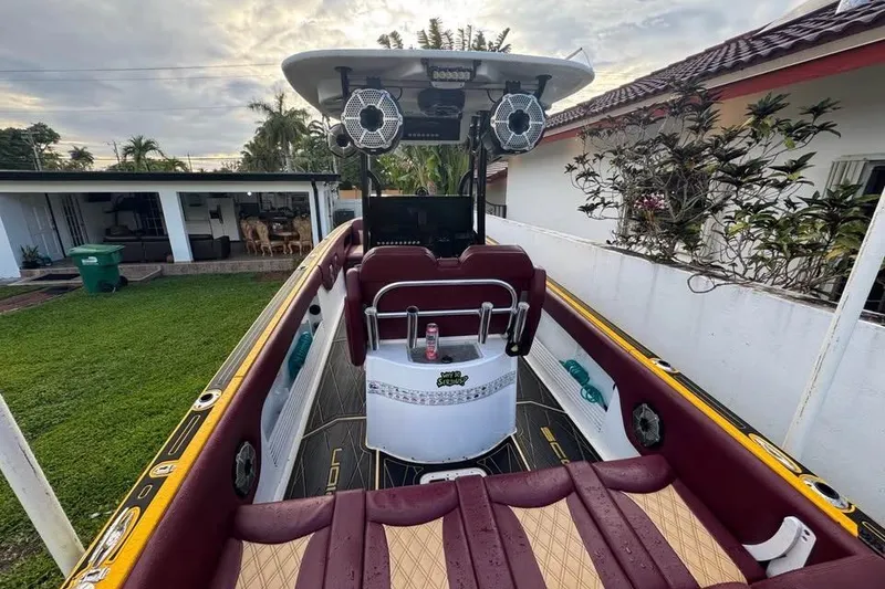 Slide: The Image of 1982 Scorpion 316 boat interior with maroon seating and modern audio system. - 13