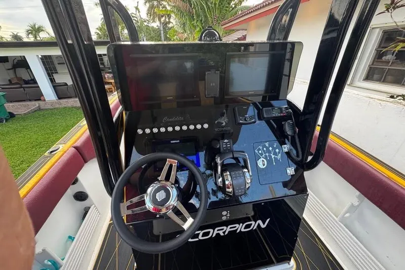 Slide: The Image of 1982 Scorpion 316 boat dashboard with steering wheel and control panel. - 18