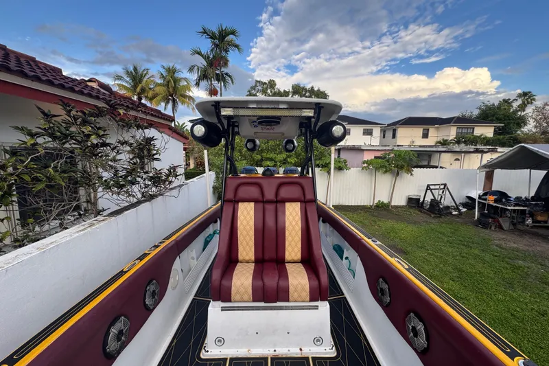 Slide: The Image of 1982 Scorpion 316 boat interior with maroon and beige seating, outdoor setting. - 9
