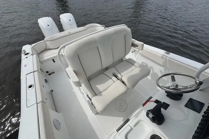 Slide: The Image of 2025 Sea Hunt Ultra 265 SE boat interior with dual engines and steering wheel. - 10