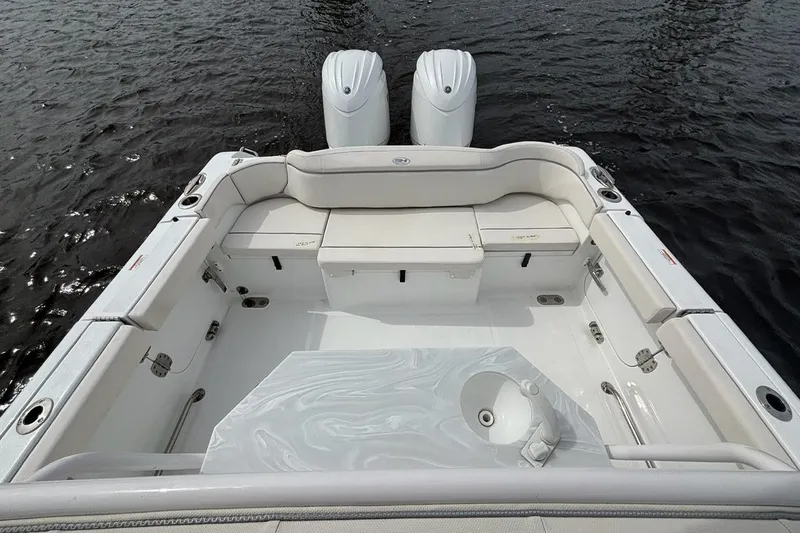 Slide: The Image of 2025 Sea Hunt Ultra 265 SE boat interior with dual engines and spacious seating. - 11