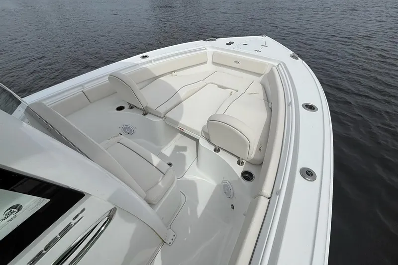 Slide: The Image of 2025 Sea Hunt Ultra 265 SE boat with spacious seating on calm water. - 6