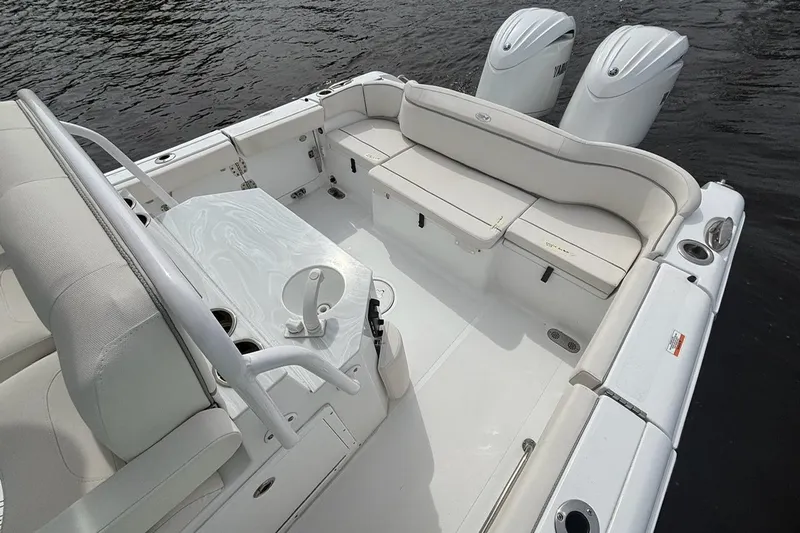 Slide: The Image of 2025 Sea Hunt Ultra 265 SE boat interior with seating and dual engines on water. - 7
