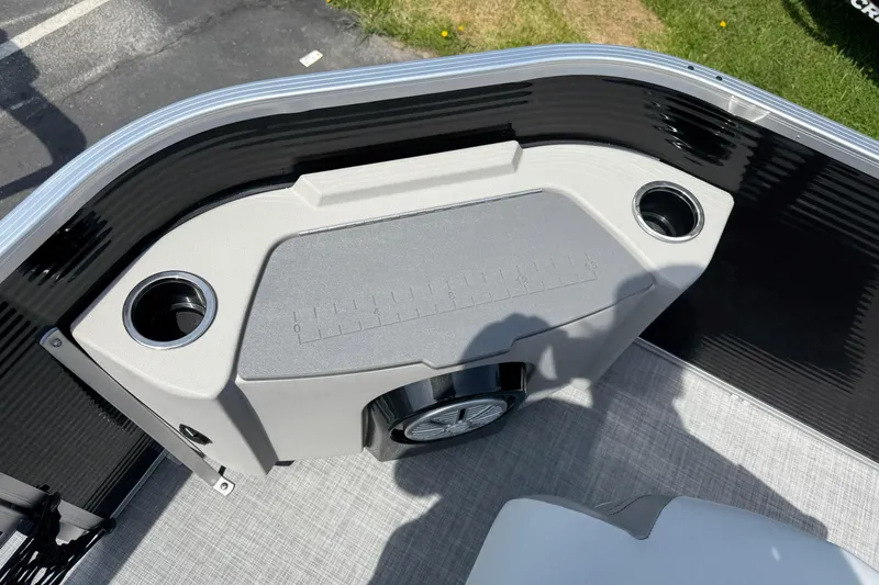 Slide: The Image of 2025 Princecraft Sportfisher 21-2S boat interior with cup holders and storage compartment. - 10