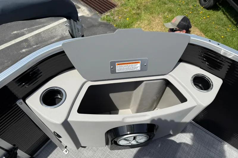 Slide: The Image of 2025 Princecraft Sportfisher 21-2S boat interior with cup holders and storage compartment. - 11