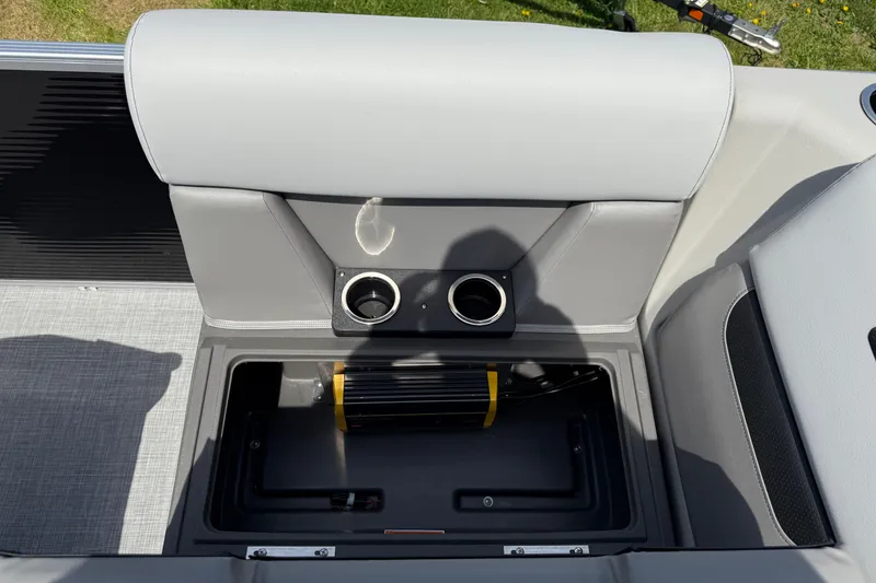 Slide: The Image of 2025 Princecraft Sportfisher 21-2S boat interior with storage compartment and cup holders. - 13