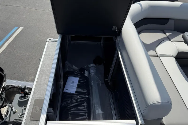 Slide: The Image of Open storage compartment in 2025 Princecraft Sportfisher 21-2S boat with manual inside. - 17