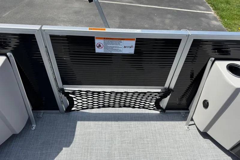 Slide: The Image of 2025 Princecraft Sportfisher 21-2S boat interior with safety netting and storage compartments. - 18