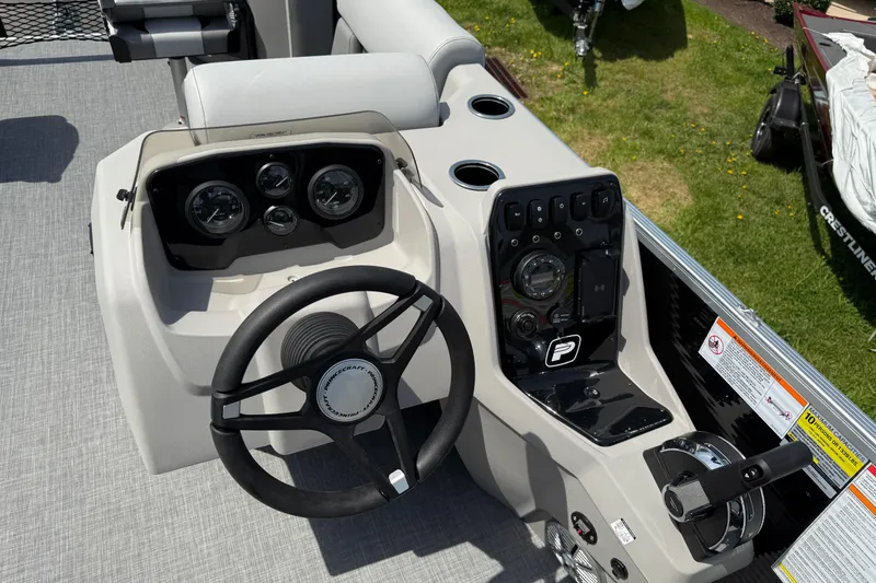 Slide: The Image of 2025 Princecraft Sportfisher 21-2S boat dashboard with steering wheel and control panel. - 5
