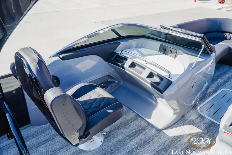 Slide: The Image of 2025 Bennington 25QSBWA boat interior with sleek helm and luxurious seating at Lake Norman Marina. - 11