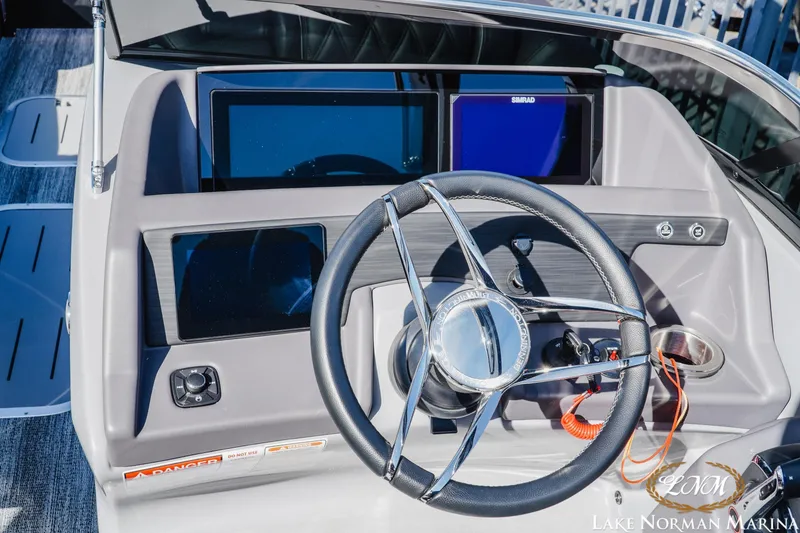 Slide: The Image of Steering console of 2025 Bennington 25QSBWA boat with modern controls and displays. - 20