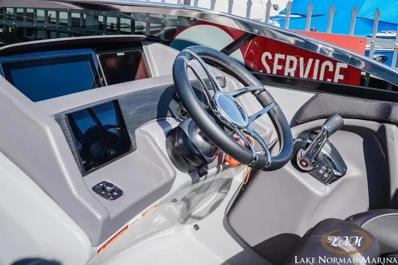 Slide: The Image of Cockpit of 2025 Bennington 25QSBWA boat with modern steering and controls at Lake Norman Marina. - 22
