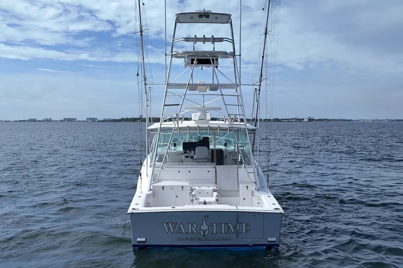 Slide: The Image of 1998 Cabo 45 Express boat on open water, rear view with fishing tower. - 12