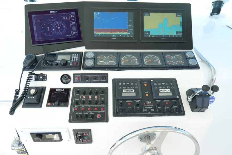 Slide: The Image of Control panel of a 1998 Cabo 45 Express boat with navigation and communication equipment. - 14