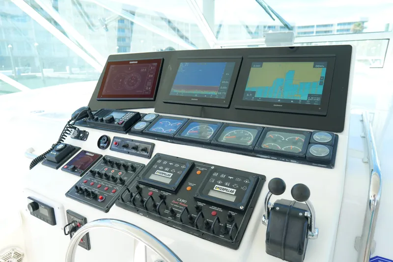 Slide: The Image of Control panel of a 1998 Cabo 45 Express boat with navigation screens and gauges. - 15