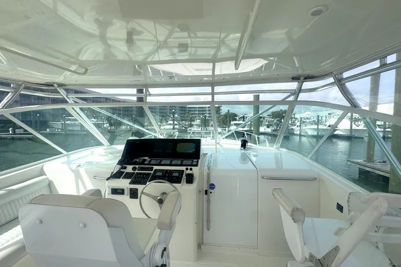 Slide: The Image of Interior view of 1998 Cabo 45 Express yacht cockpit with marina background. - 17