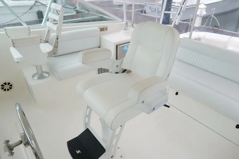 Slide: The Image of Luxurious white seating on a 1998 Cabo 45 Express yacht's helm area. - 19