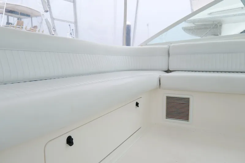 Slide: The Image of Interior seating of 1998 Cabo 45 Express boat with white upholstery. - 21