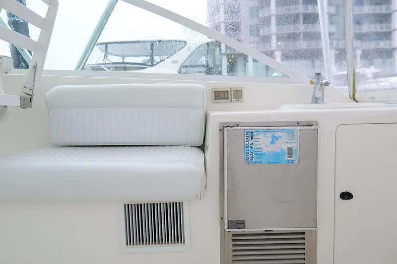 Slide: The Image of Interior of a 1998 Cabo 45 Express boat with white seating and control panel. - 23