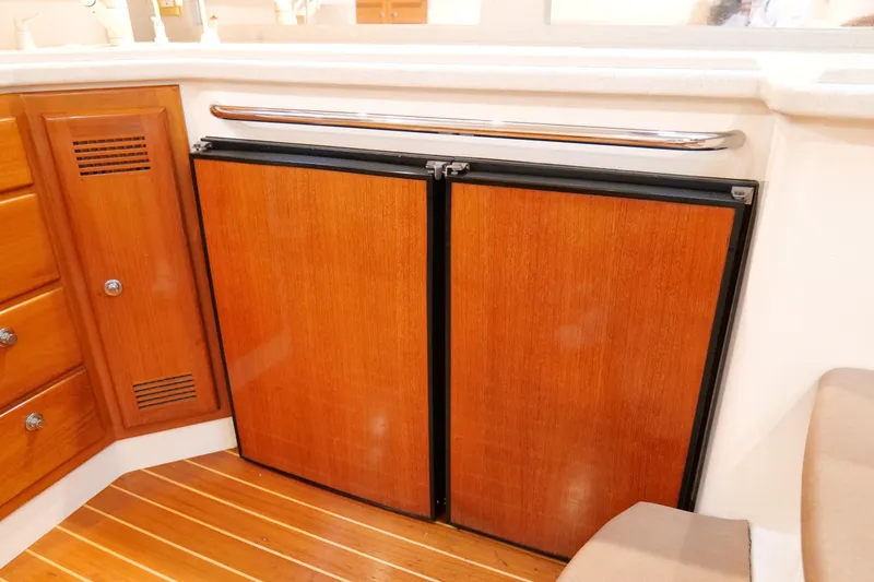 Slide: The Image of Wooden cabinetry and fridge in 1998 Cabo 45 Express yacht interior. - 25