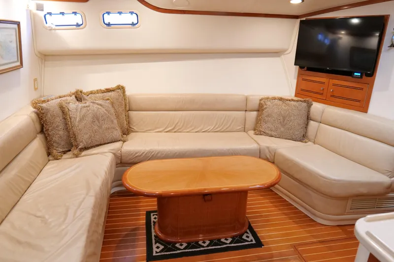 Slide: The Image of Luxurious 1998 Cabo 45 Express yacht interior with plush seating and elegant decor. - 28