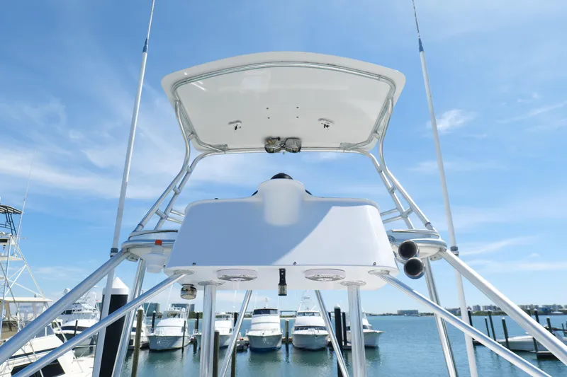 Slide: The Image of Cabo 45 Express 1998 boat tower with blue sky and marina background. - 34
