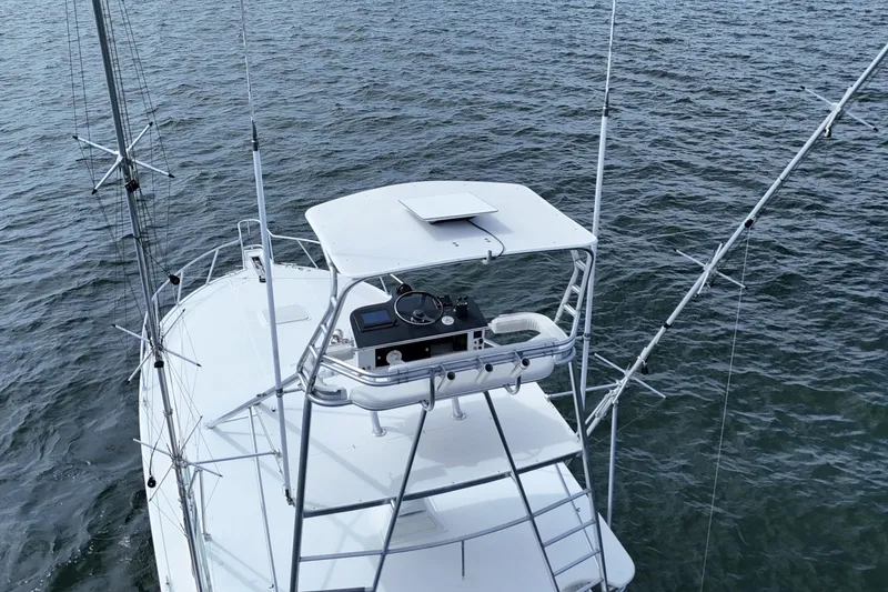 Slide: The Image of Aerial view of 1998 Cabo 45 Express boat on water with fishing outriggers. - 35