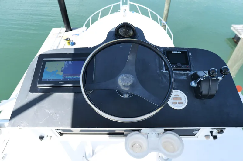 Slide: The Image of Helm of 1998 Cabo 45 Express boat with navigation equipment and steering wheel. - 36