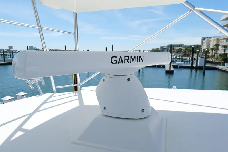 Slide: The Image of Garmin radar on 1998 Cabo 45 Express yacht, docked at marina under clear blue sky. - 40