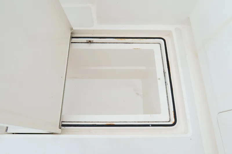 Slide: The Image of Open hatch on 1998 Cabo 45 Express boat, showcasing storage compartment. - 45