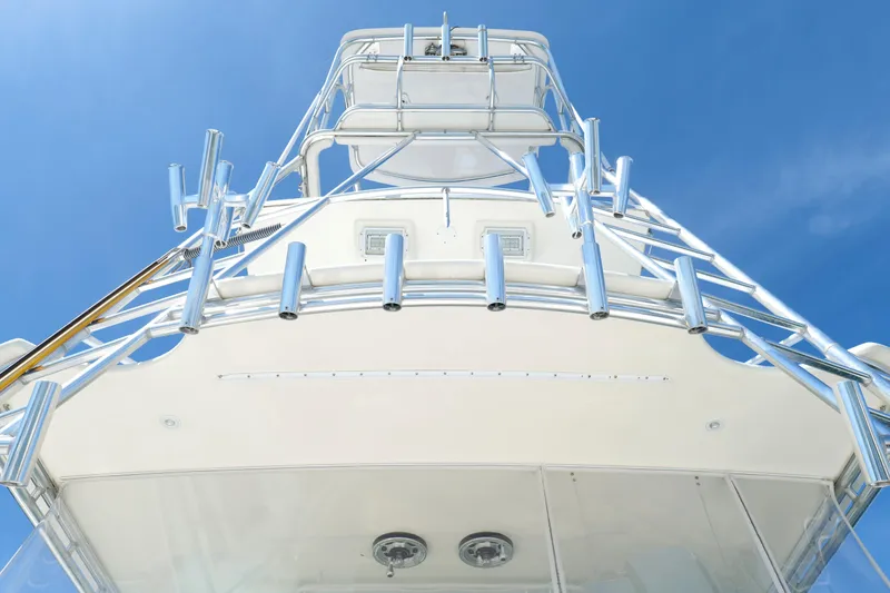 Slide: The Image of 1998 Cabo 45 Express yacht tower against clear blue sky. - 49