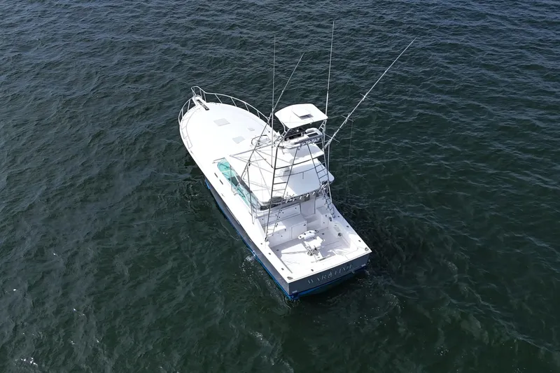 Slide: The Image of Aerial view of a 1998 Cabo 45 Express boat on open water. - 5