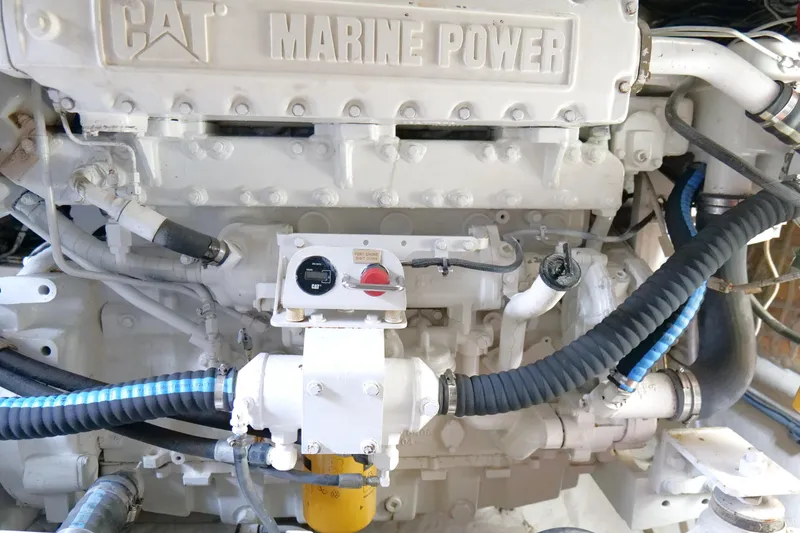 Slide: The Image of Cabo 45 Express 1998 engine, featuring CAT marine power components and hoses. - 50