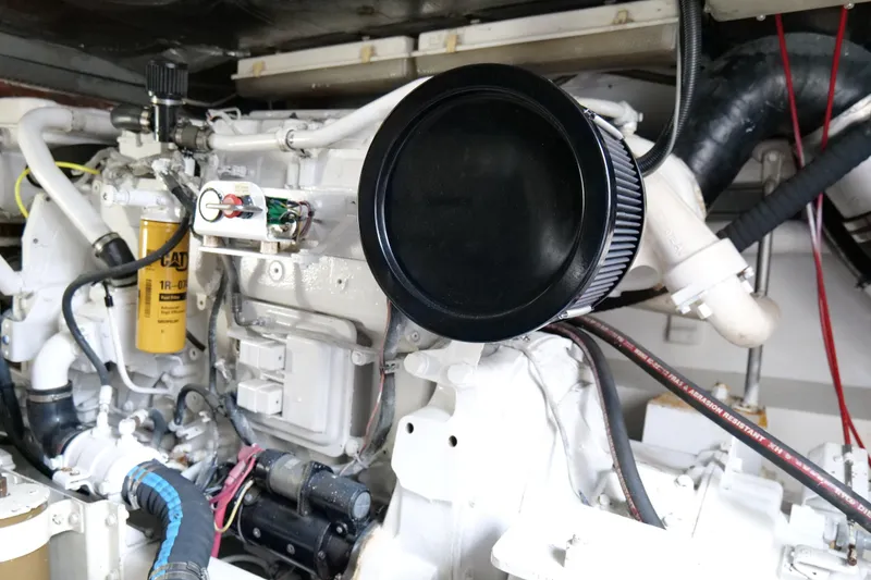 Slide: The Image of Engine compartment of a 1998 Cabo 45 Express boat, featuring detailed mechanical components. - 51