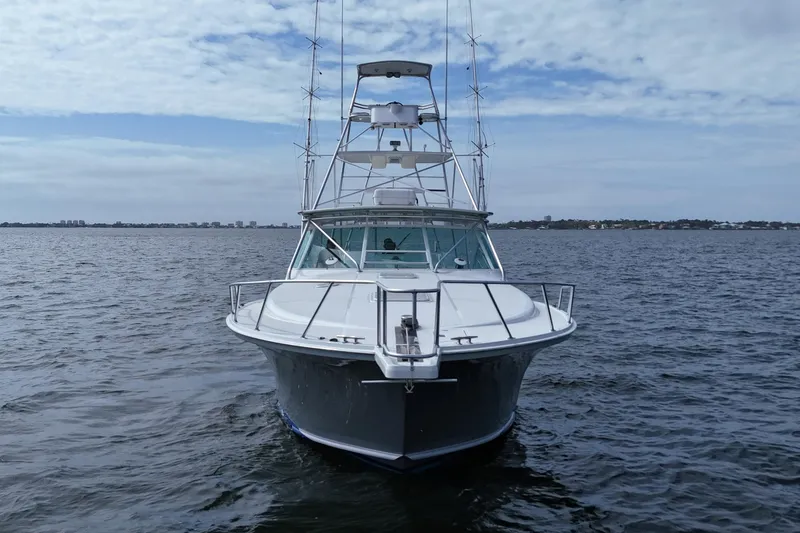 Slide: The Image of 1998 Cabo 45 Express boat on open water under cloudy sky. - 8