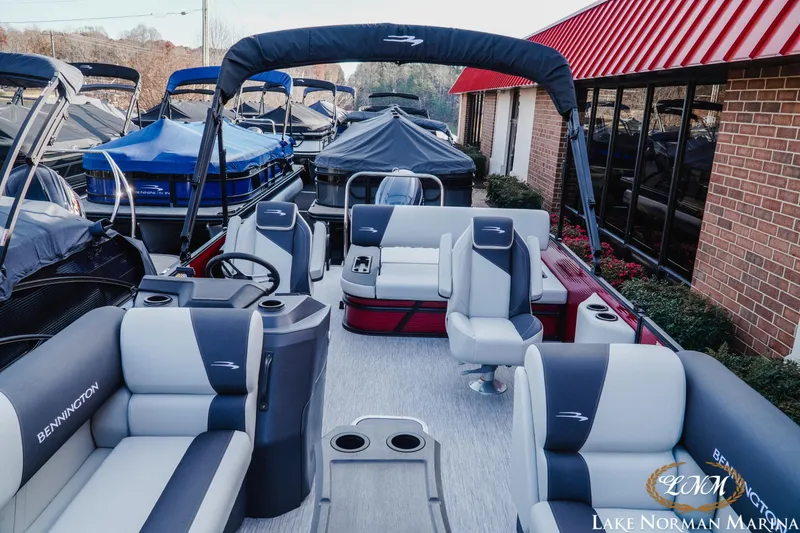 Slide: The Image of 2026 Bennington 22SSB pontoon boat at Lake Norman Marina, featuring spacious seating. - 10
