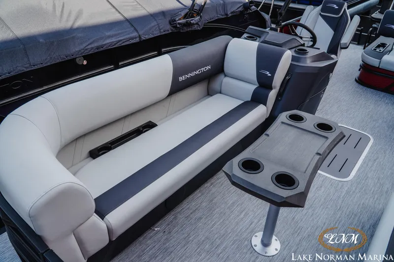 Slide: The Image of 2026 Bennington 22SSB pontoon boat interior with plush seating and cup holders. - 12