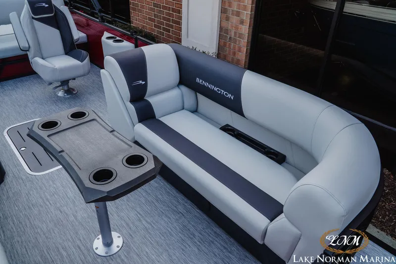 Slide: The Image of 2026 Bennington 22SSB pontoon boat interior with plush seating and cup holders. - 13