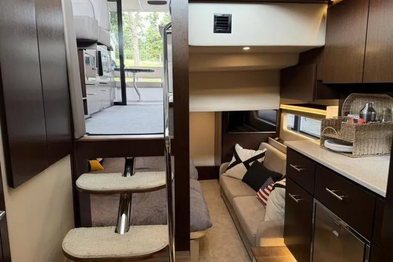 Slide: The Image of Interior of 2017 Regal 42 Grande Coupe yacht with modern kitchen and cozy seating area. - 12