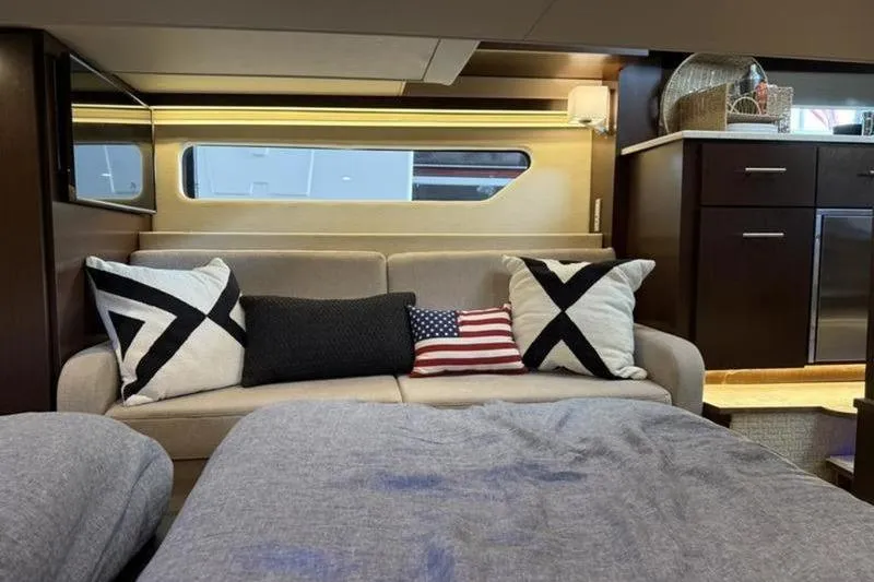 Slide: The Image of Interior of 2017 Regal 42 Grande Coupe with cozy seating and decorative pillows. - 13