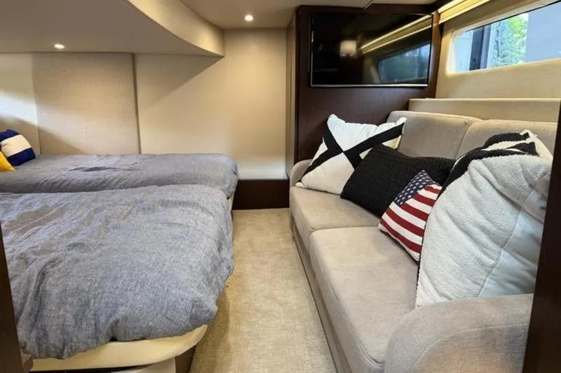 Slide: The Image of Interior of 2017 Regal 42 Grande Coupe with cozy seating and bedding. - 15