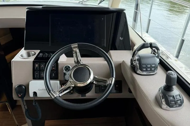 Slide: The Image of Helm of 2017 Regal 42 Grande Coupe with steering wheel and control panel. - 16