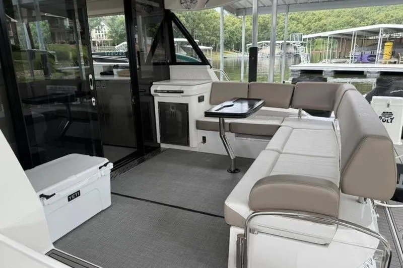 Slide: The Image of Luxurious seating area on a 2017 Regal 42 Grande Coupe yacht, docked by the water. - 20